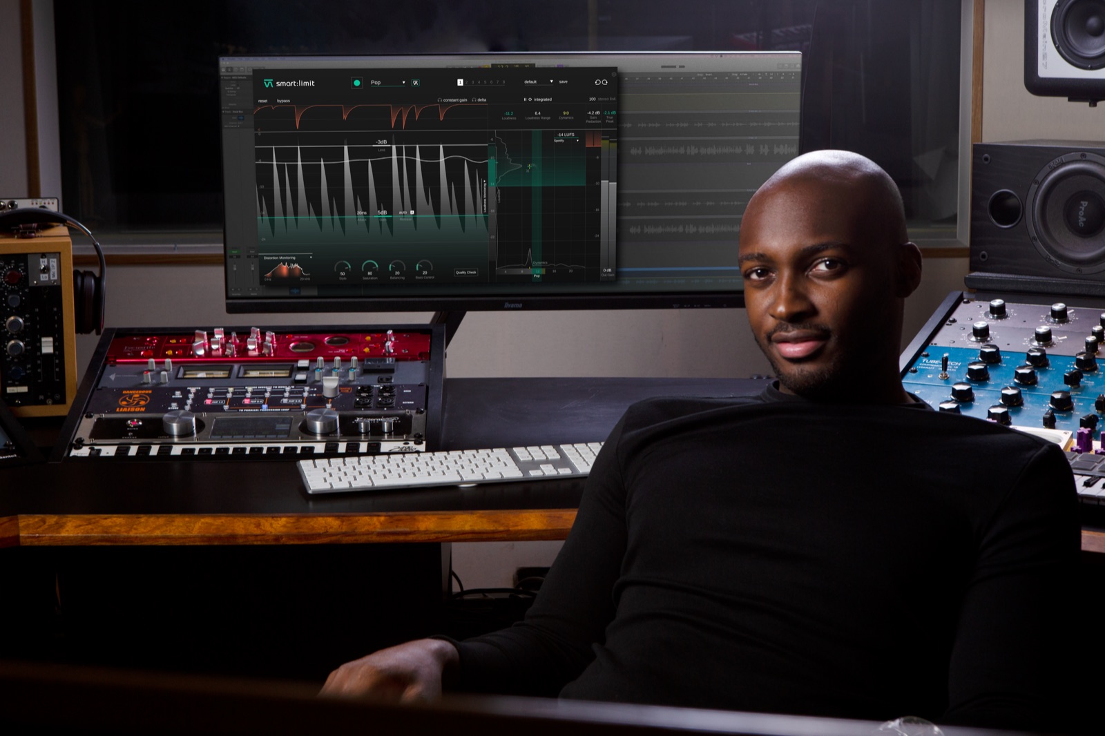 Producer in a studio with a plug-in on the big screen